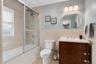 Primary bathroom with glass-enclosed shower.