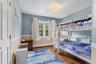 Second bedroom with double windows and neutral tones.