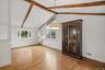 Dining area w/ hardwood floors and fresh paint.