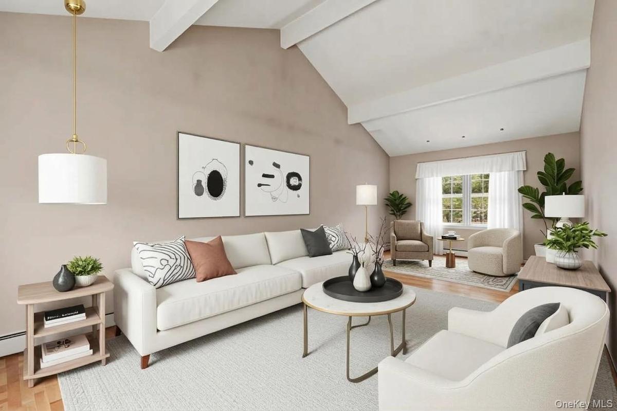 This living room can accommodate numerous seating areas. Virtually staged