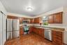 Plenty of wood cabinetry, stainless steel appliances and granite counter tops make meal prep a breeze.