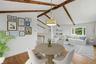 Virtually staged dining area w/ hardwood floors and fresh paint.