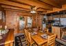 Wood-paneled interior featuring exposed ceiling beams and recessed lighting