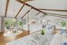 Virtually staged open-plan great room w/ hardwood floors, exposed wood beams, and fresh paint.