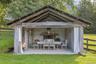 Pool Cabana made from over-sized trees from the property with an over-sized  fireplace