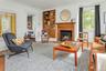 Another beautiful  fireplace, high ceilings and over-sized windows