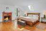 Large primary bedroom w/skylight, large windows  and fireplace