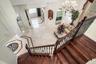 Hardwood stairs with wrought iron style balusters up to 2nd floor loft area and 3 additional bedrooms