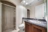 1st floor full bathroom with shower off of hallway leading to 2nd ground floor bedroom (currently media room)