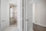 Shower enclosure with a glass door, built-in bench, and tile surround