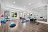 Spacious room featuring expansive mirrored wall, tray ceiling - invite your personal trainer