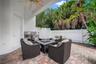 Covered patio featuring a ceiling fan, paver flooring, with a built-in grill, and a privacy fence