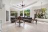 Expansive living space - walls of windows for natural light, marble flooring