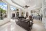 Expansive windows overlooking a private courtyard with lush landscaping and a pool