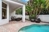 Brick paver patio with a built-in grill, covered lanai