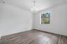 Crown molding, wood-finish flooring, and a chandelier
