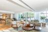 Living room featuring billiards table, floor to ceiling windows, light wood-type flooring, recessed lighting, and a raised ceiling
