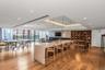 Kitchen with open floor plan, a large island, light stone countertops, recessed lighting, and pendant lighting