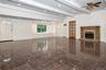 1300 sq ft of additional living space with fireplace and walk out to back yard and garage.  AI Generated
