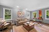 Wood flooring, recessed lighting, crown molding, and multiple windows with white trim