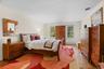 Hardwood flooring throughout, featuring multiple windows, and light-toned wall finishes