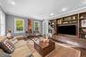 Recessed lighting, crown molding, wood-finish flooring, and multiple windows