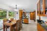 Kitchen and dining area featuring wood-finish cabinetry, and integrated stainless steel appliances