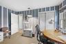 Room with striped wallpaper, a built-in sliding closet, a window with exterior views, and a recessed ceiling light fixture