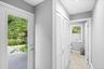 From kitchen. Laundry behind white louvered bifold doors, recessed ceiling lighting, and light gray wall paint