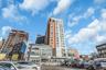 View of apartment building / complex with a city view and uncovered parking