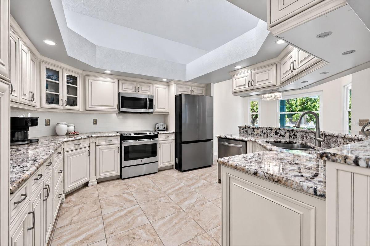 Furniture-grade cabinetry, granite countertops, stainless steel appliances, and loads of under cabinet lighting