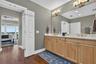 Dual walk-in closets in hall between bath & bed