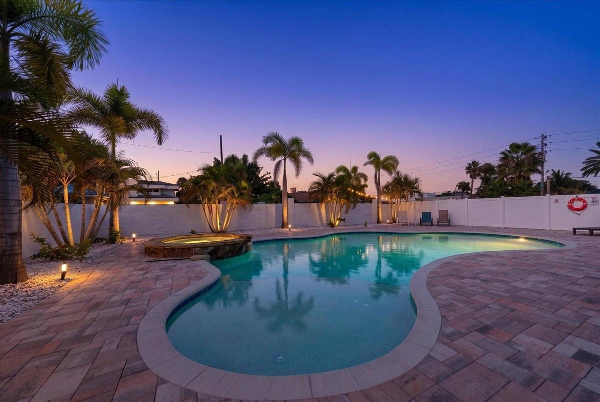 Completely fenced heated pool with abundant deck area.