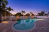 Completely fenced heated pool with abundant deck area.