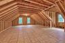 Expansive unfinished 2nd floor area featuring exposed wood framing, wood subflooring, and multiple windows