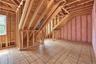 Unfinished 2nd floor space featuring wood framing, subflooring, and 2 windows