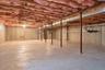 Unfinished basement with concrete walls, concrete flooring, and visible insulation