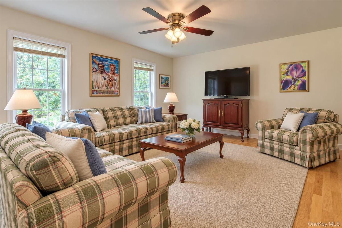 Recessed lighting, wood-finish flooring, and a ceiling fan with integrated lighting