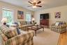 Recessed lighting, wood-finish flooring, and a ceiling fan with integrated lighting