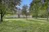 Expansive grassy yard with mature trees