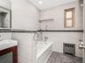 Bathroom featuring vanity, tile walls, radiator, and tile patterned floors