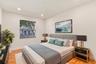 Both upstairs guest bedrooms are generously sized and filled with natural light, offering ample closet space and comfortable accommodations for family