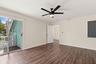 The elegant primary suite offers a private retreat with a beautifully updated bathroom, spacious walk-in closets, and a private balcony overlooking th