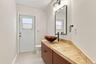 Tastefully updated and conveniently located just off the living room, the powder room offers comfort and convenience for residents and guests alike.