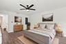 The elegant primary suite offers a private retreat with a beautifully updated bathroom, spacious walk-in closets, and a private balcony overlooking th