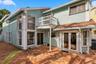 The private backyard is designed for effortless Florida living, featuring an expansive Spanish tile patio with a covered area for year-round enjoyment