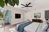 The elegant primary suite offers a private retreat with a beautifully updated bathroom, spacious walk-in closets, and a private balcony overlooking th