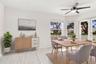 The charming eat-in dining area provides a relaxed and convenient setting for casual meals, surrounded by natural light with sliding glass doors openi