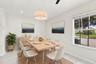 The charming eat-in dining area provides a relaxed and convenient setting for casual meals, surrounded by natural light with sliding glass doors openi