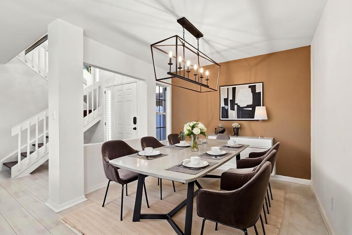 The open-concept floor plan seamlessly connects the living room and elegant formal dining area, creating an inviting setting for memorable dinners and